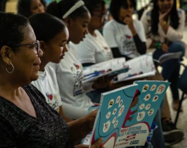 Grupo de niñas leyendo con una profesora