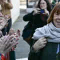 Giséle Pelicot, camiando en frente de mujeres que la aplauden